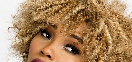 Mixed looking woman with blonde coiled afro hair