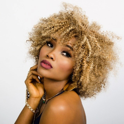 Mixed looking woman with blonde coiled afro hair