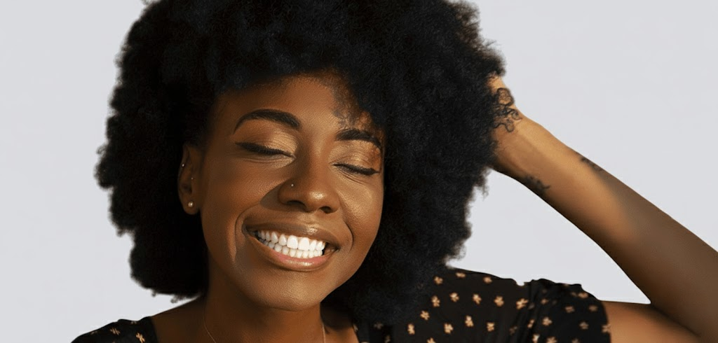 Dark hair black woman with afro and smiling